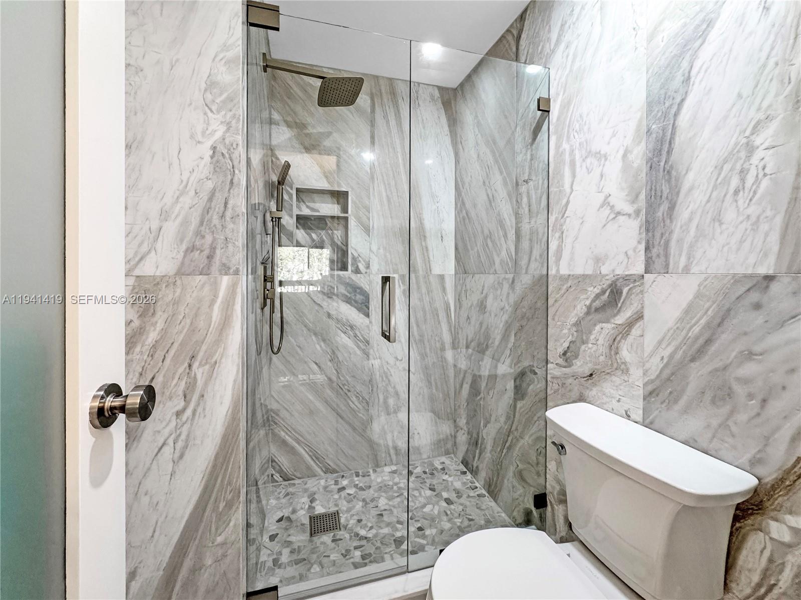 1977 Southwest 15th Street, Unit 116 Deerfield Beach, FL 33442 - Photo 13 of 37 a white toilet sitting next to a bathroom sink