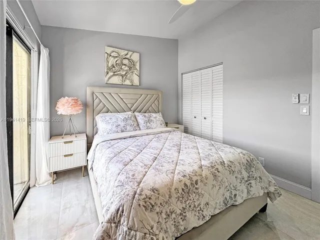 a bedroom with a large bed and a large window