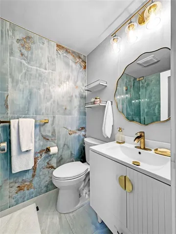 a bathroom with a sink a toilet and a mirror