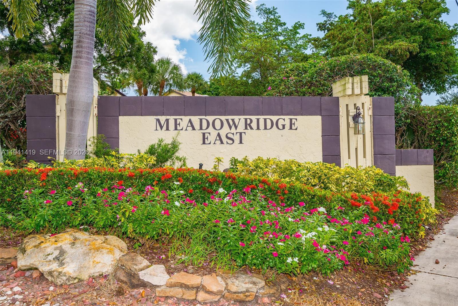 1977 Southwest 15th Street, Unit 116 Deerfield Beach, FL 33442 - Photo 20 of 37 a sign on the side of the road