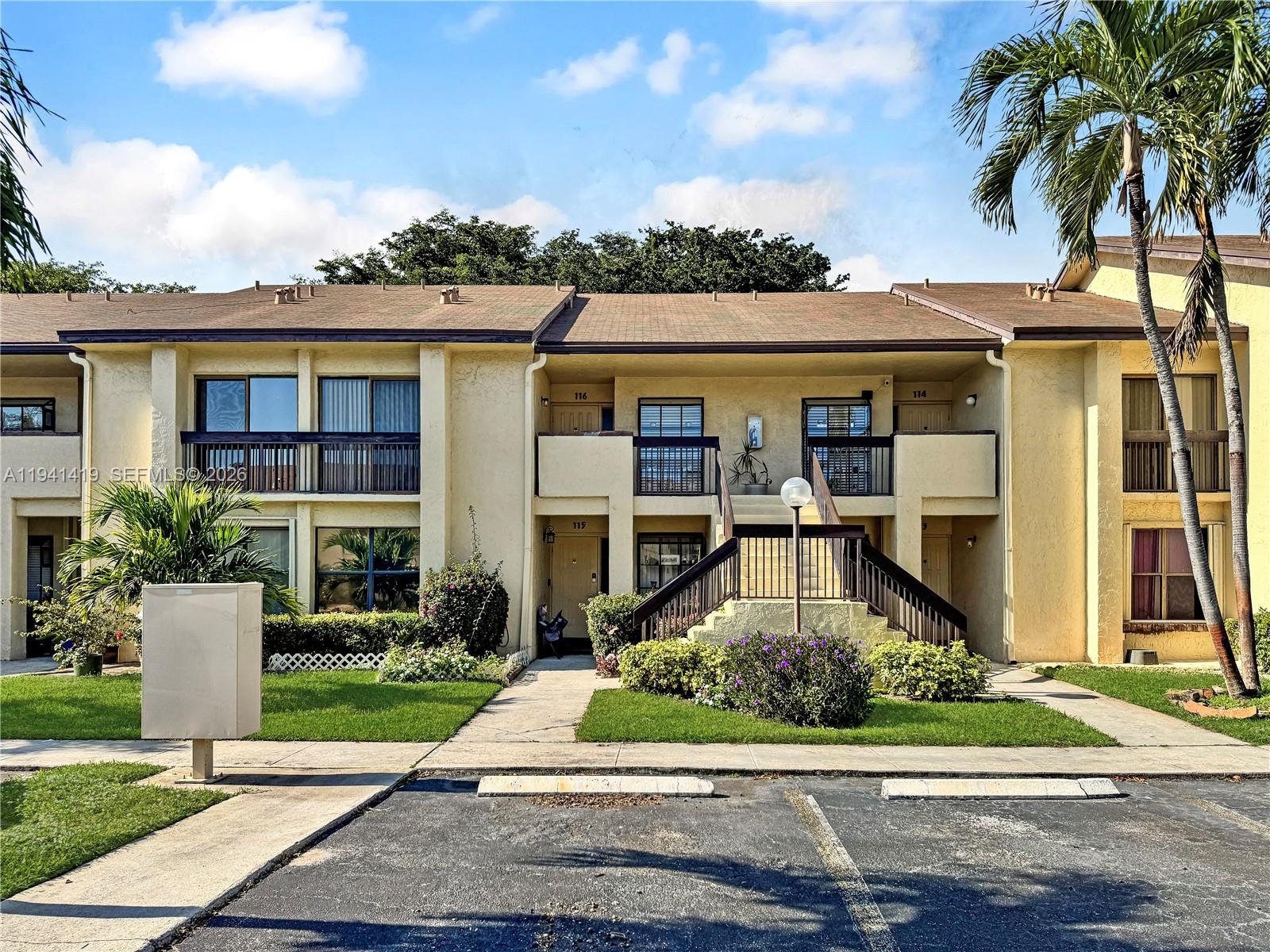 1977 Southwest 15th Street, Unit 116 Deerfield Beach, FL 33442 - Photo 22 of 37 front view of a house with a yard