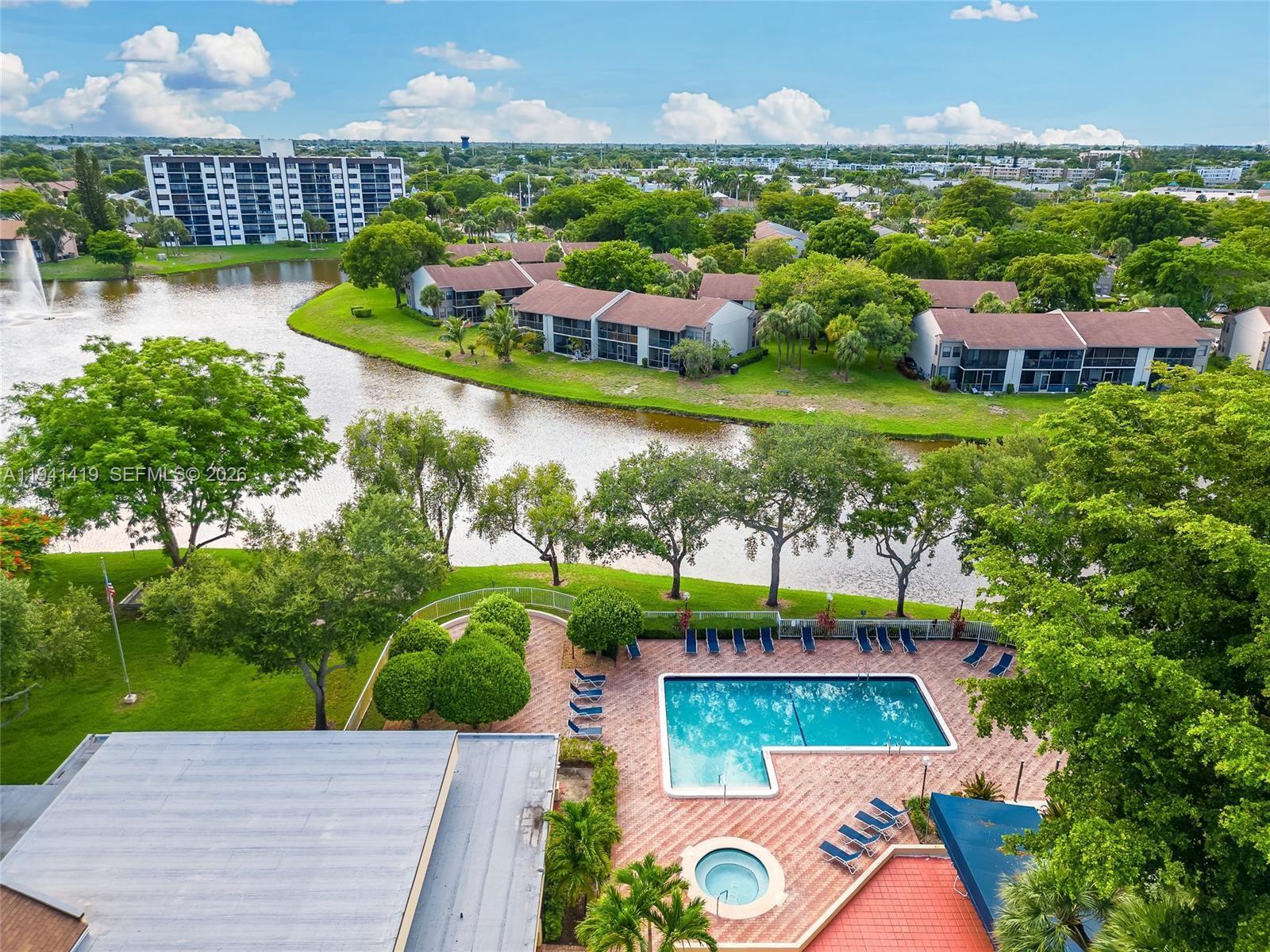 1977 Southwest 15th Street, Unit 116 Deerfield Beach, FL 33442 - Photo 26 of 37 a view of a swimming pool with a patio