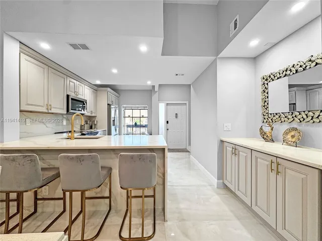 a kitchen with sink cabinets and window