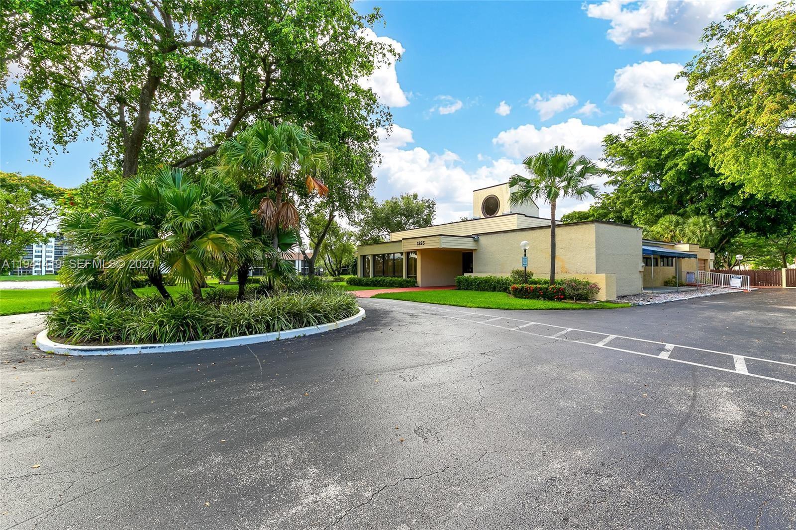 1977 Southwest 15th Street, Unit 116 Deerfield Beach, FL 33442 - Photo 31 of 37 a front view of a house with a yard
