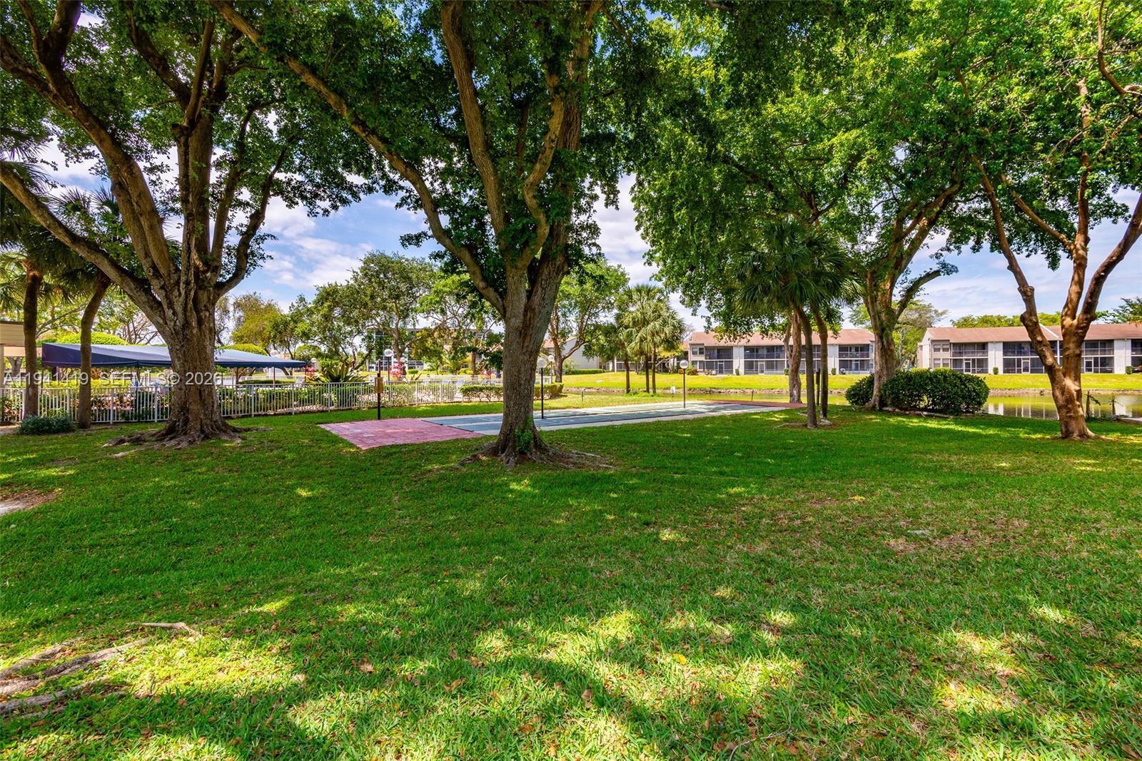 1977 Southwest 15th Street, Unit 116 Deerfield Beach, FL 33442 - Photo 32 of 37 a view of green field with trees