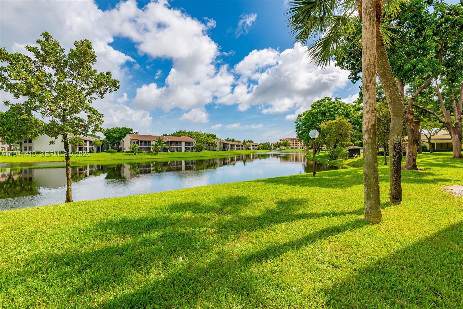 1977 Southwest 15th Street, Unit 116 Deerfield Beach, FL 33442 - Photo 33 of 37 a view of a golf course with a garden