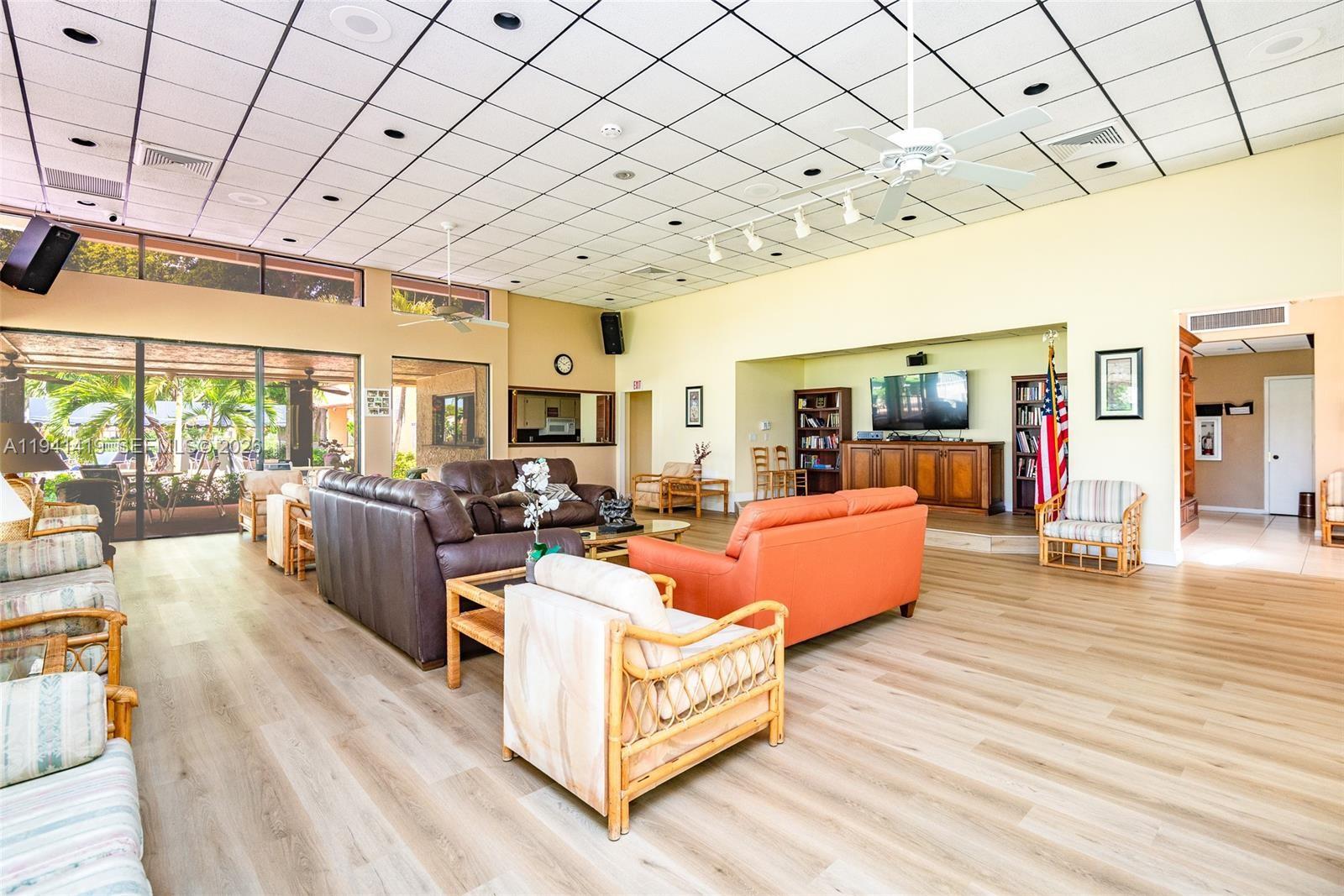 1977 Southwest 15th Street, Unit 116 Deerfield Beach, FL 33442 - Photo 34 of 37 a living room with furniture and a large window