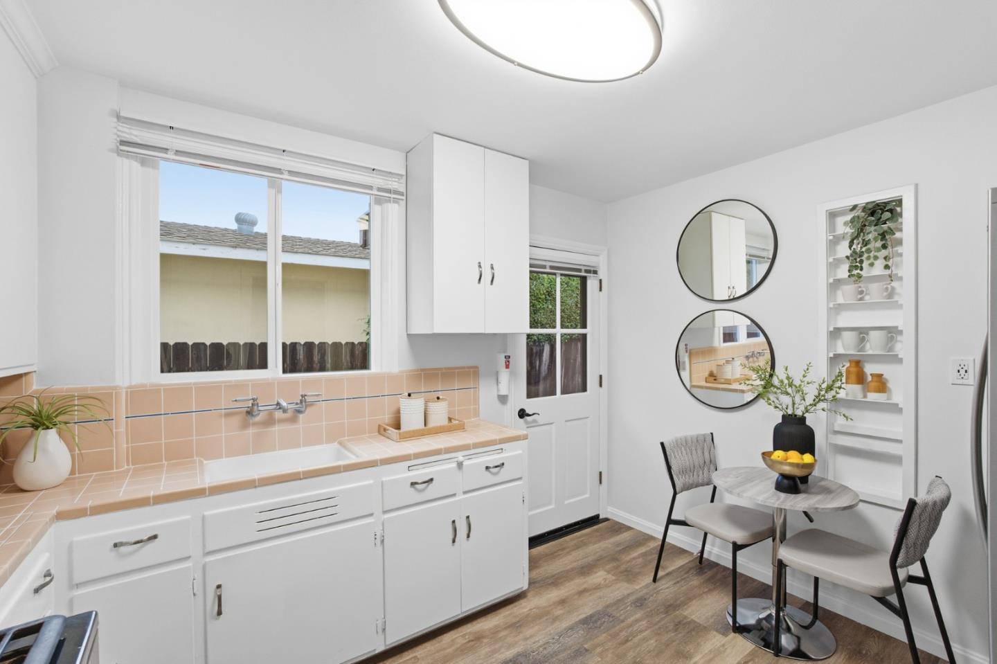200 Anita Road Burlingame, CA 94010 - Photo 12 of 50 a spacious bathroom with a granite countertop sink and a mirror