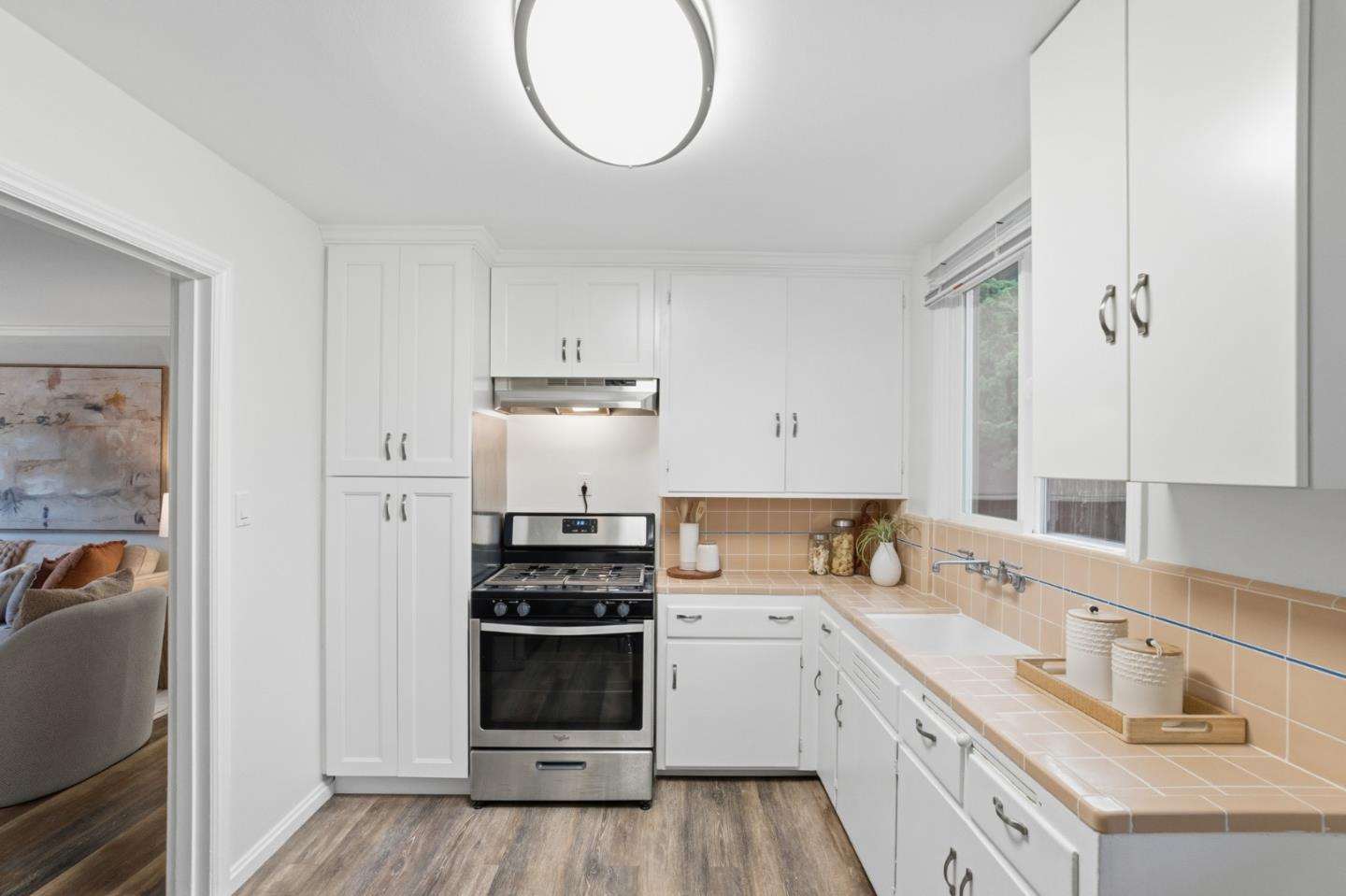200 Anita Road Burlingame, CA 94010 - Photo 14 of 50 a kitchen with stainless steel appliances a sink a stove a refrigerator and cabinets