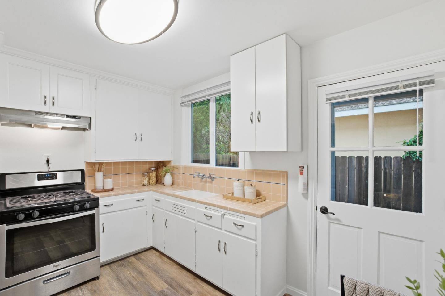 200 Anita Road Burlingame, CA 94010 - Photo 15 of 50 a kitchen with a sink stove and cabinets