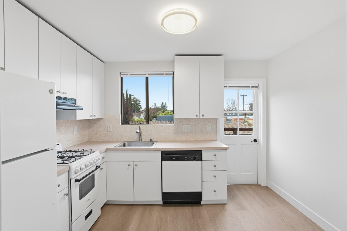 200 Anita Road Burlingame, CA 94010 - Photo 37 of 50 a kitchen with white cabinets and white appliances