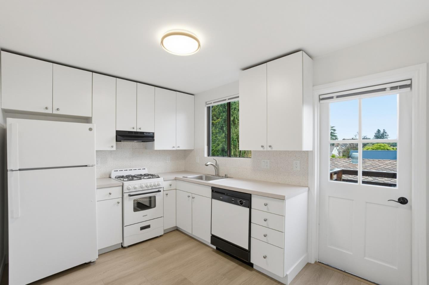 200 Anita Road Burlingame, CA 94010 - Photo 38 of 50 a kitchen with white cabinets and white appliances