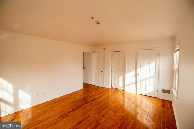 a view of an empty room and wooden floor