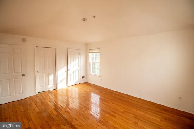 a view of an empty room and wooden floor