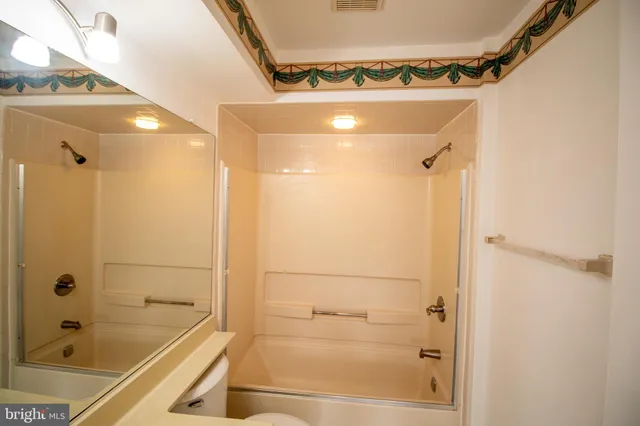 a bathroom with a tub and shower