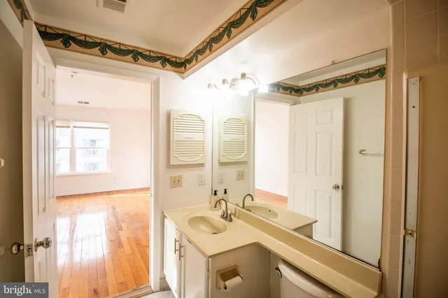a bathroom with a sink mirror and a shower