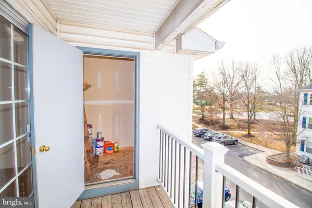 a view of a room that has a window and wooden floor
