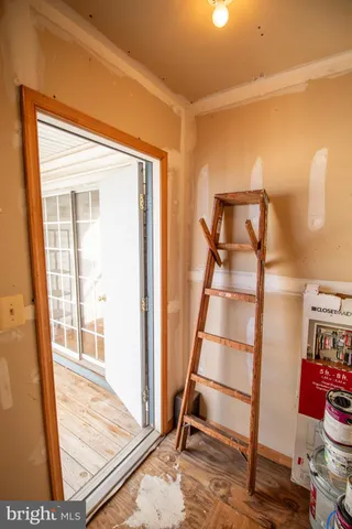 a view of an empty room and wooden floor and a window