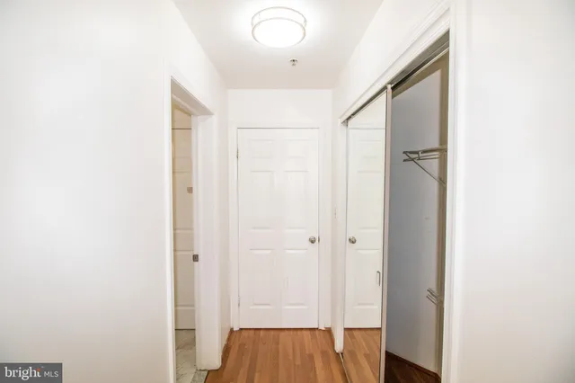a view of a hallway with wooden floor