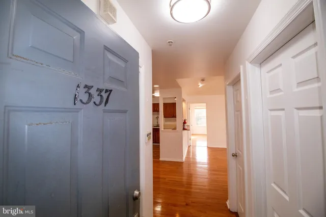 a view of a hallway with wooden floor
