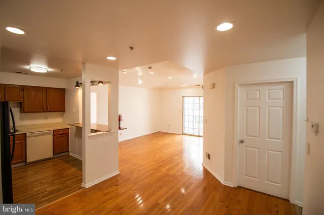 a view of a kitchen with a sink and a refrigerator