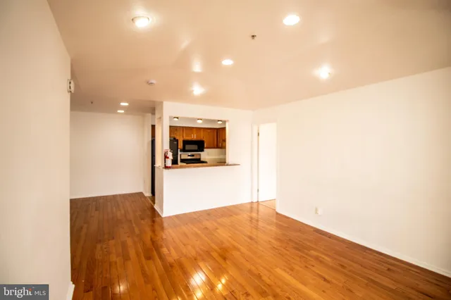 a view of empty room with wooden floor
