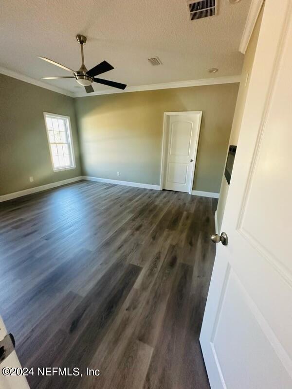 868 Jones Road Jacksonville, FL 32220 - Photo 16 of 19 a view of empty room with wooden floor and fan