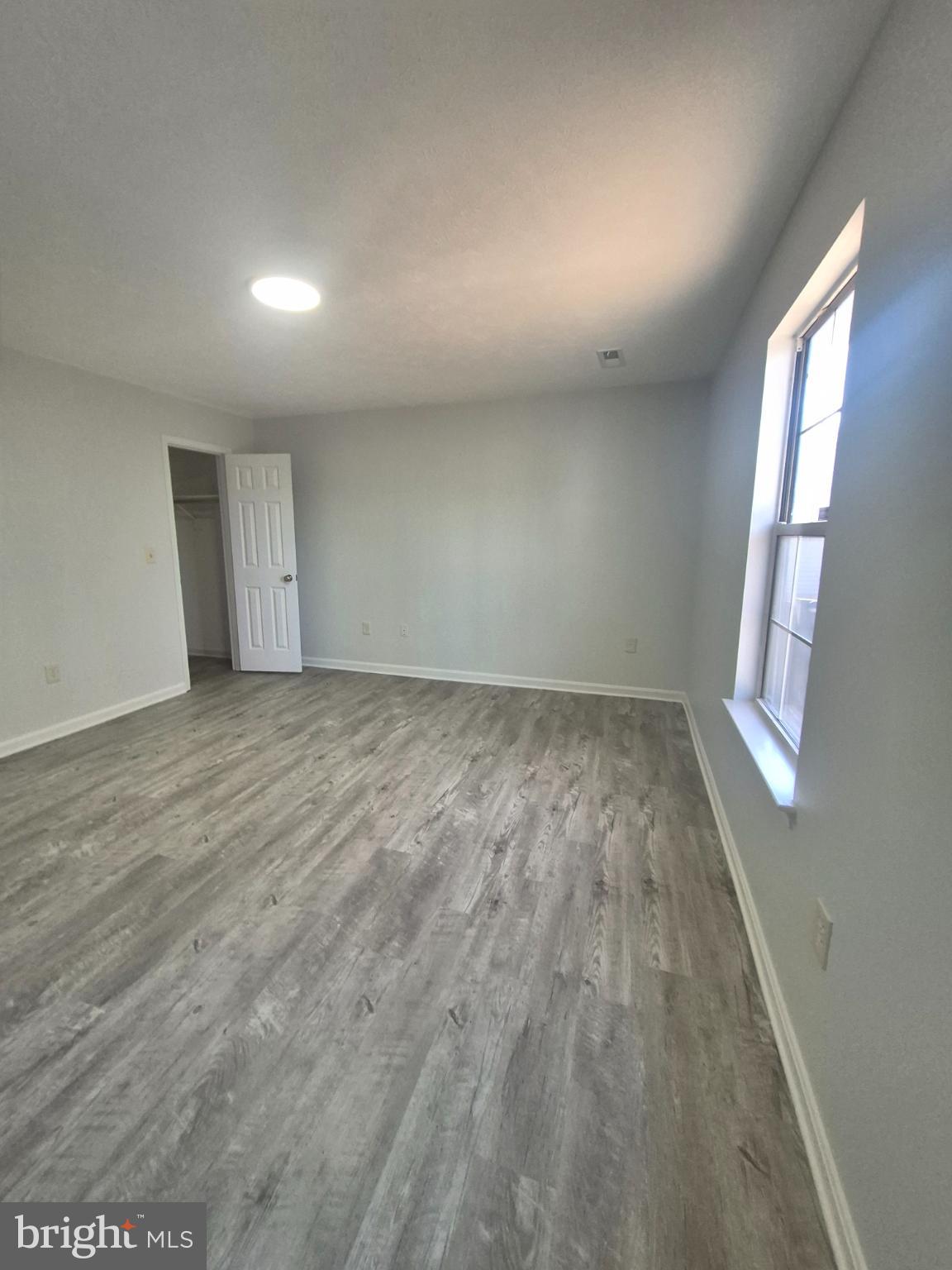 2855 Stavors Road Waldorf, MD 20603 - Photo 22 of 34 an empty room with wooden floor and windows