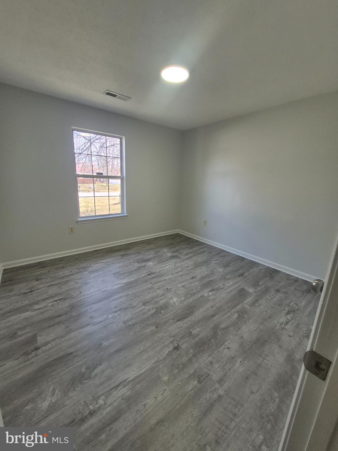 2855 Stavors Road Waldorf, MD 20603 - Photo 29 of 34 an empty room with wooden floor and windows