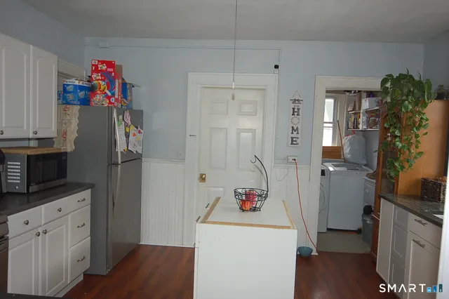 a storage room with wooden floor and cabinets