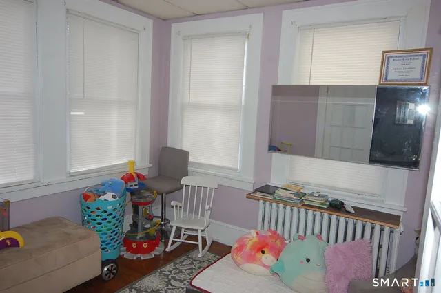 a bedroom with furniture and a window