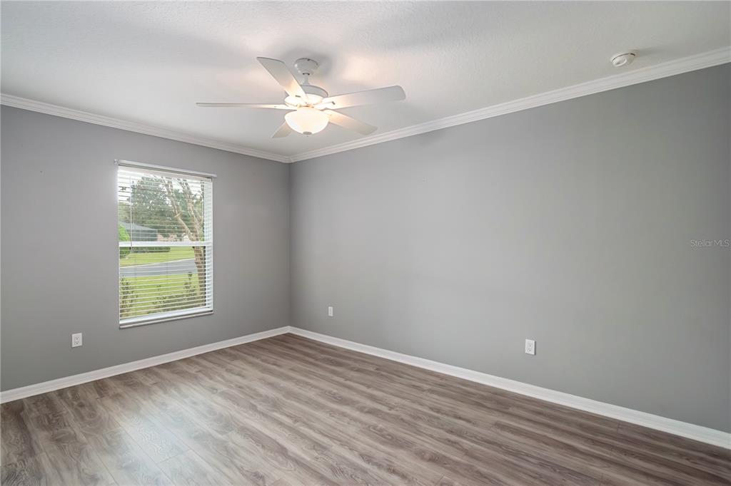 15692 Southwest 11th Court Road Ocala, FL 34473 - Photo 20 of 49 an empty room with wooden floor fan and windows
