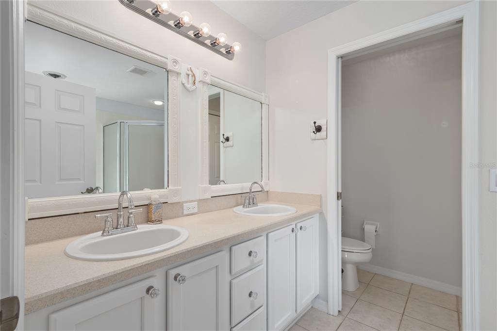 15692 Southwest 11th Court Road Ocala, FL 34473 - Photo 33 of 49 a bathroom with a sink a toilet and a mirror