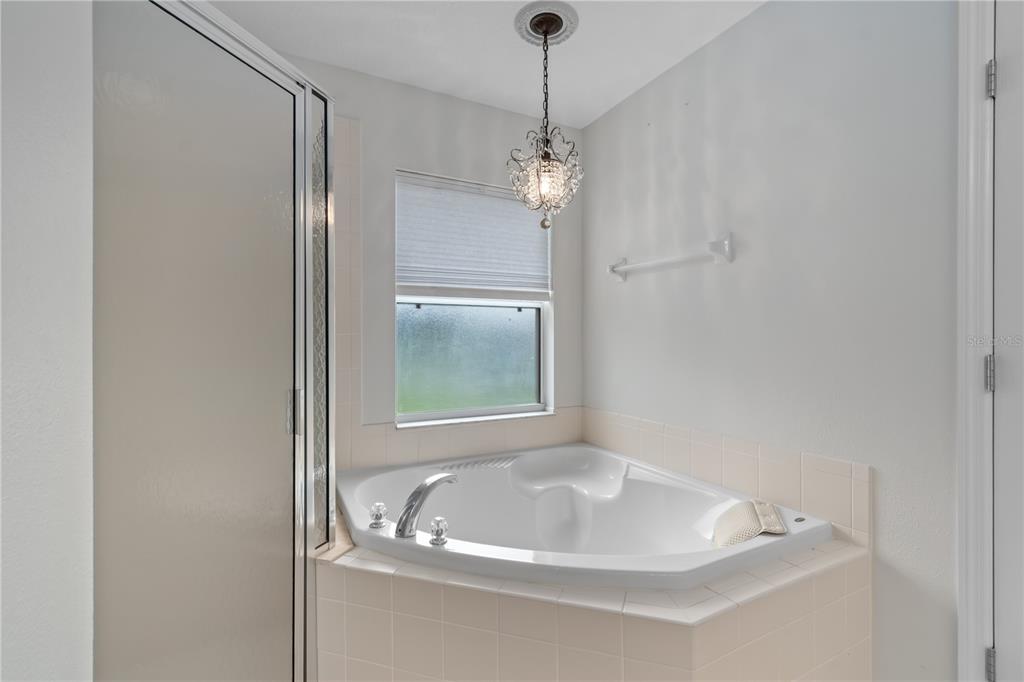 15692 Southwest 11th Court Road Ocala, FL 34473 - Photo 34 of 49 a bathroom with a sink a window and a mirror