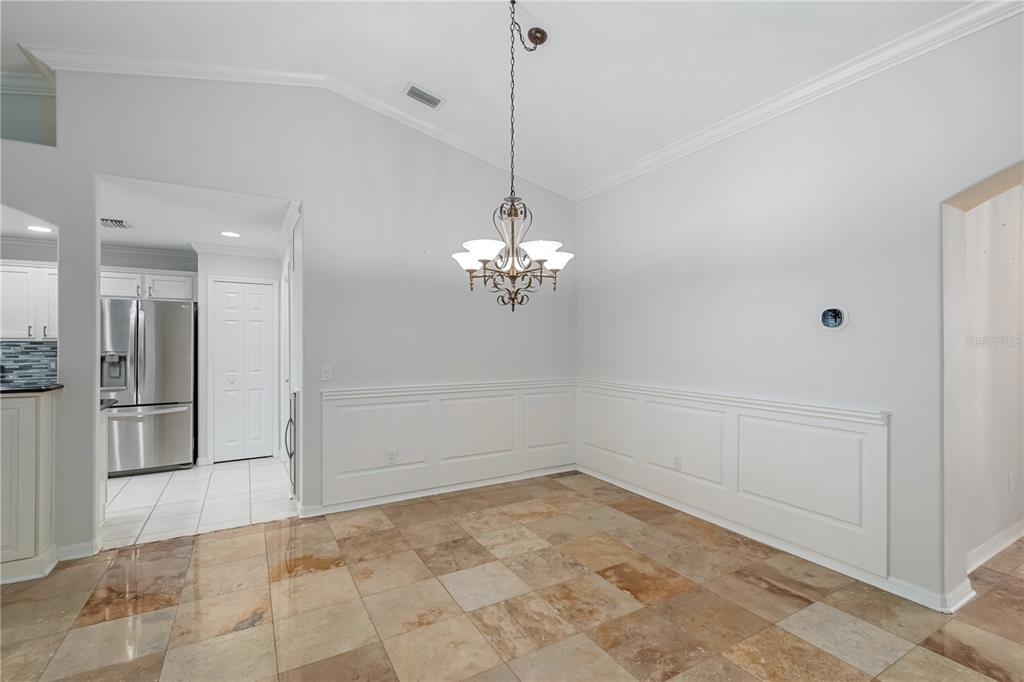 15692 Southwest 11th Court Road Ocala, FL 34473 - Photo 37 of 49 a view of a room with a chandelier fan and refrigerator