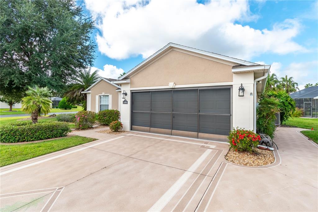 15692 Southwest 11th Court Road Ocala, FL 34473 - Photo 5 of 49 a front view of a house with a yard and garage