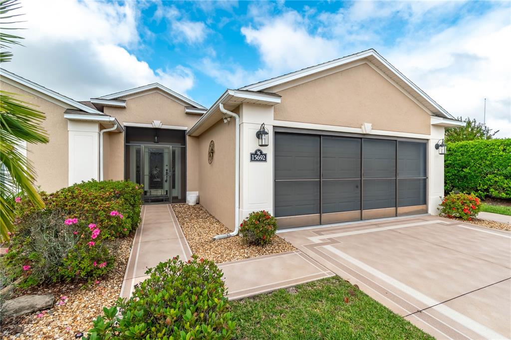 15692 Southwest 11th Court Road Ocala, FL 34473 - Photo 6 of 49 a front view of a house with a yard and garage