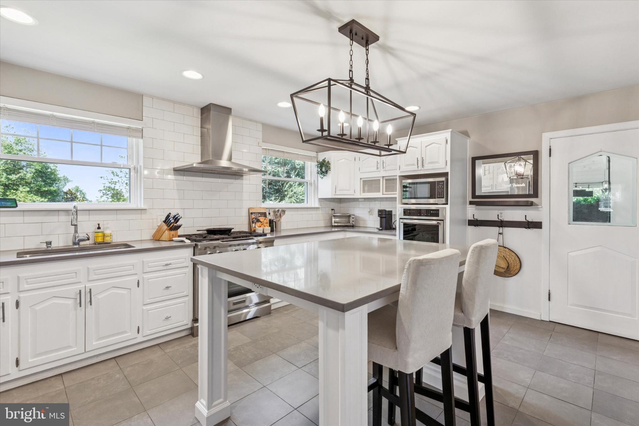 3029 Arch Road Norristown, PA 19401 - Photo 8 of 27 a kitchen with stainless steel appliances a center island cabinets and wooden floor