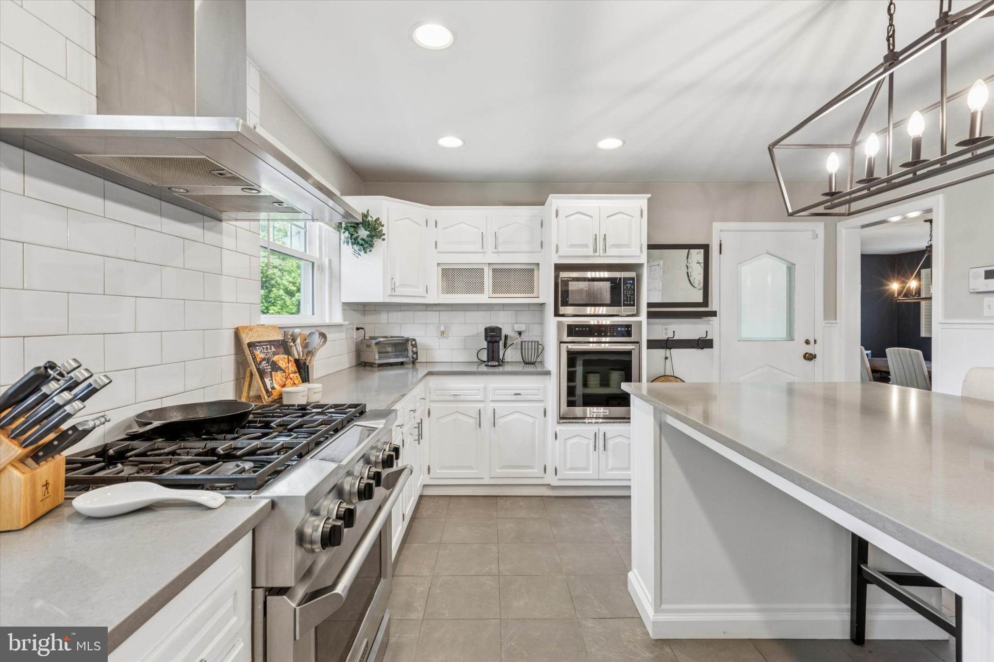 3029 Arch Road Norristown, PA 19401 - Photo 9 of 27 a large kitchen with stainless steel appliances granite countertop a lot of counter space and wooden floor