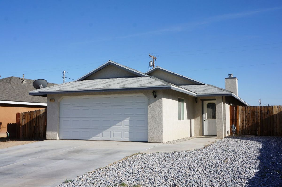 1005 West Coronado Avenue Ridgecrest, CA 93555 - Photo 1 of 1 a front view of a house with a yard and garage