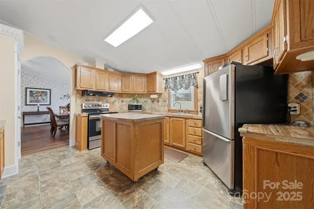 a kitchen with stainless steel appliances a refrigerator stove and sink