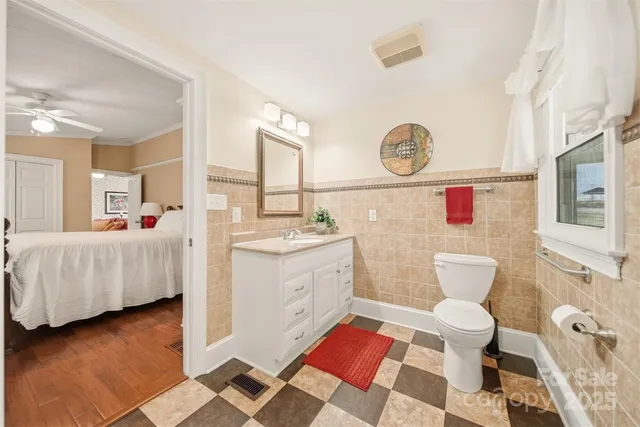 a bathroom with a sink toilet and a mirror