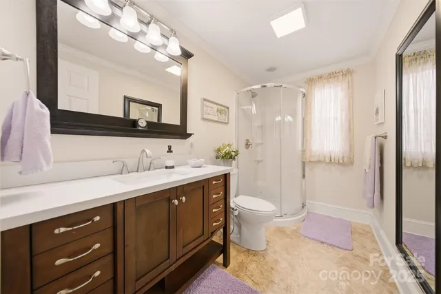 a spacious bathroom with a double vanity sink mirror and toilet