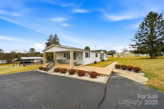 a view of swimming pool with outdoor seating and yard in the back