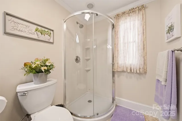 a bathroom with a toilet and a shower