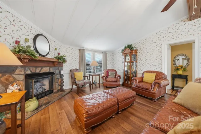 a living room with furniture a fireplace and a flat screen tv