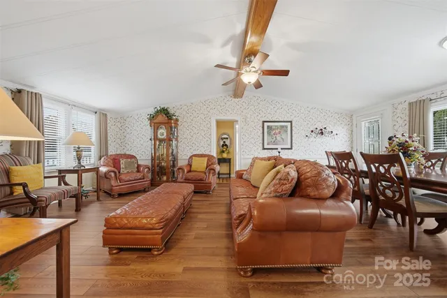 a living room with furniture wooden floor and a window