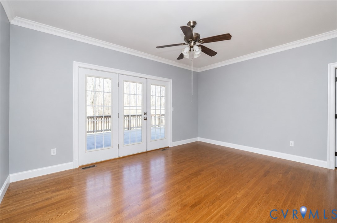 239 Jennings Road Cartersville, VA 23027 - Photo 13 of 26 Spacious room featuring light gray walls, wood-fin