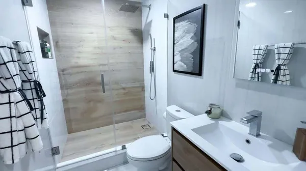 a bathroom with a sink toilet and shower