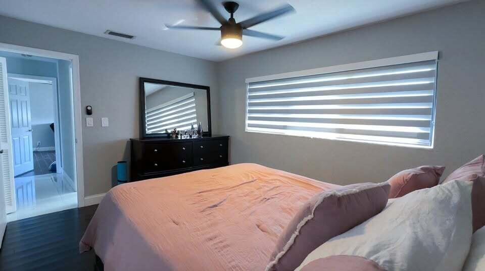 7410 Southwest 15th Street Plantation, FL 33317 - Photo 12 of 14 a bedroom with a bed and window